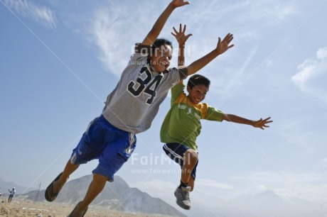 Fair Trade Photo 10-15 years, Activity, Casual clothing, Clothing, Colour image, Day, Emotions, Friendship, Fun, Happiness, Horizontal, Jumping, Latin, Outdoor, People, Peru, Sky, South America, Two boys, Two children