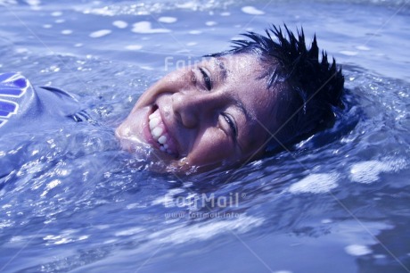 Fair Trade Photo 10-15 years, Activity, Colour image, Emotions, Happiness, Horizontal, Latin, Looking at camera, One boy, One child, People, Peru, Playing, Portrait headshot, Smile, Smiling, South America, Sport, Swimming, Water
