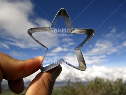 Fair Trade Photo Christmas, Closeup, Colour image, Finger, Focus on foreground, Horizontal, Outdoor, Peru, Silver, Sky, South America, Star, Tabletop