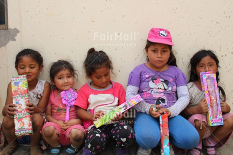 Fair Trade Photo 10-15 years, 5 -10 years, Activity, Child, Children, Colour image, Day, Female, Friendship, Girls, Group, Horizontal, Latin, Multi-coloured, Outdoor, People, Peru, Playground, Playing, Rural, School, Sitting, South America, Street