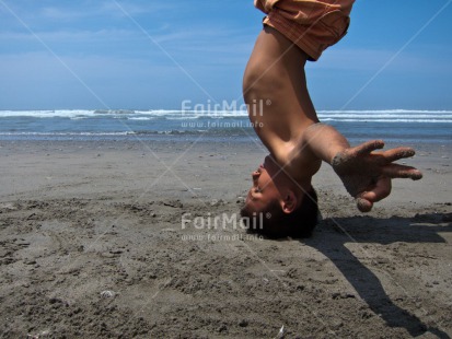 Fair Trade Photo 5 -10 years, Activity, Beach, Colour image, Day, Doing handstand, Horizontal, Latin, One boy, Outdoor, People, Peru, Sea, South America, Yoga