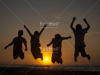 Fair Trade Photo Activity, Backlit, Beach, Colour image, Emotions, Evening, Friendship, Group of boys, Group of children, Happiness, Horizontal, Jumping, Outdoor, People, Peru, Sea, Silhouette, South America, Sunset, Water