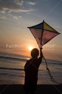 Fair Trade Photo Activity, Backlit, Beach, Colour image, Evening, Freedom, Kite, One boy, Outdoor, People, Peru, Playing, Sea, Silhouette, Sky, South America, Wind