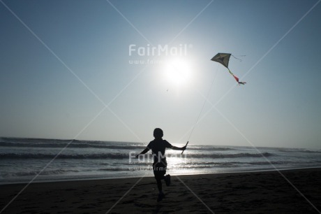 Fair Trade Photo Activity, Backlit, Beach, Colour image, Evening, Freedom, Kite, One boy, Outdoor, People, Peru, Playing, Sea, Silhouette, Sky, South America, Wind