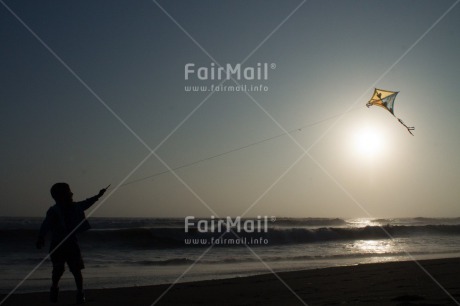 Fair Trade Photo Activity, Backlit, Beach, Colour image, Evening, Freedom, Kite, One boy, Outdoor, People, Peru, Playing, Sea, Silhouette, Sky, South America, Wind