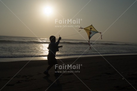 Fair Trade Photo Activity, Backlit, Beach, Colour image, Evening, Freedom, Kite, One boy, Outdoor, People, Peru, Playing, Sea, Silhouette, Sky, South America, Wind