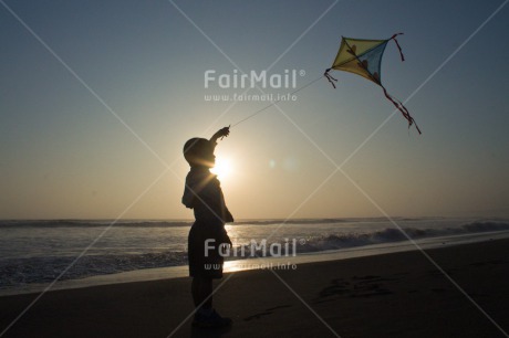 Fair Trade Photo Activity, Backlit, Beach, Colour image, Evening, Freedom, Kite, One boy, Outdoor, People, Peru, Playing, Sea, Silhouette, Sky, South America, Wind