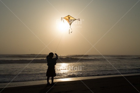 Fair Trade Photo Activity, Backlit, Beach, Colour image, Evening, Freedom, Kite, One boy, Outdoor, People, Peru, Playing, Sea, Silhouette, Sky, South America, Wind