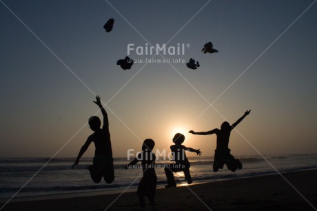 Fair Trade Photo Activity, Backlit, Beach, Colour image, Cooperation, Emotions, Evening, Friendship, Group of boys, Happiness, Jumping, Outdoor, People, Peru, Playing, Sand, Sea, Silhouette, South America, Summer, Throwing, Together