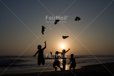 Fair Trade Photo Activity, Backlit, Beach, Colour image, Cooperation, Emotions, Evening, Friendship, Group of boys, Happiness, Jumping, Outdoor, People, Peru, Playing, Sand, Sea, Silhouette, South America, Summer, Throwing, Together