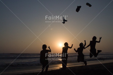 Fair Trade Photo Activity, Backlit, Beach, Colour image, Cooperation, Emotions, Evening, Friendship, Group of boys, Happiness, Jumping, Outdoor, People, Peru, Playing, Sand, Sea, Silhouette, South America, Summer, Throwing, Together