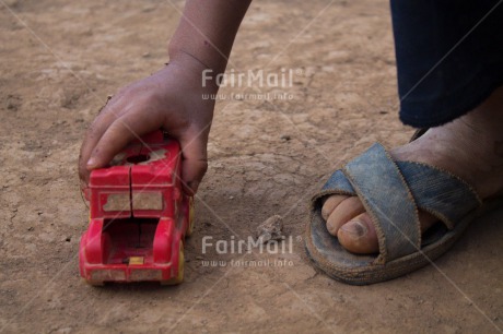 Fair Trade Photo Activity, Car, Closeup, Clothing, Colour image, Ethnic-folklore, Foot, Hand, One boy, One child, People, Peru, Playing, Rural, Sandals, South America, Traditional clothing, Transport