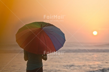 Fair Trade Photo Beach, Colour image, Evening, Horizontal, One girl, Outdoor, People, Sea, Summer, Sunset, Umbrella