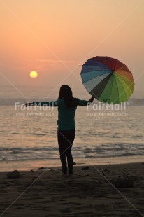 Fair Trade Photo Beach, Colour image, Evening, One girl, Outdoor, People, Peru, Sea, South America, Summer, Sunset, Umbrella, Vertical
