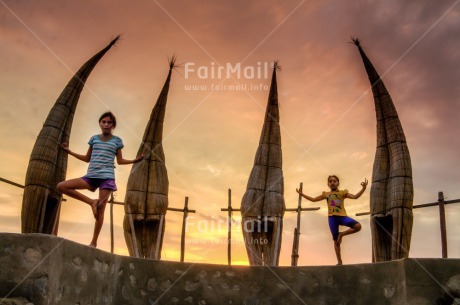 Fair Trade Photo Balance, Colour image, Evening, Fishing boat, Horizontal, Huanchaco, Outdoor, Peace, People, Peru, Sky, South America, Spirituality, Two girls, Wellness, Yoga, Youth