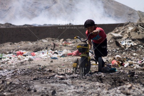 Fair Trade Photo Activity, Bicycle, Colour image, Garbage belt, Horizontal, Looking at camera, One boy, People, Peru, Portrait halfbody, Poverty, Smiling, South America, Transport