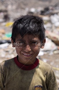 Fair Trade Photo Activity, Colour image, Garbage belt, Looking at camera, One boy, People, Peru, Portrait halfbody, Poverty, Smiling, South America, Vertical