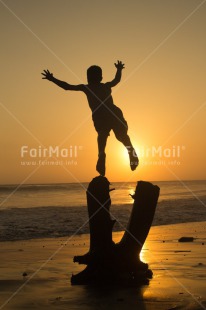 Fair Trade Photo Activity, Beach, Colour image, Emotions, Happiness, Holiday, Jumping, One boy, People, Peru, Playing, Sea, South America, Summer, Sunset, Vertical