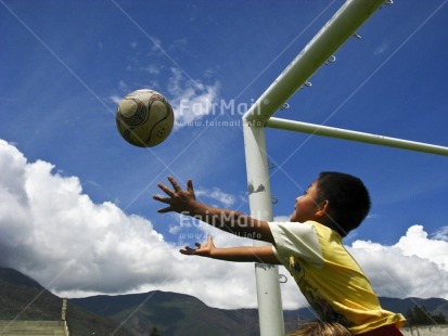 Fair Trade Photo Activity, Ball, Catching, Colour image, Fun, Goal, Health, Horizontal, Multi-coloured, One boy, Outdoor, People, Peru, Playing, Portrait halfbody, Reaching, Sky, Soccer, South America, Sport