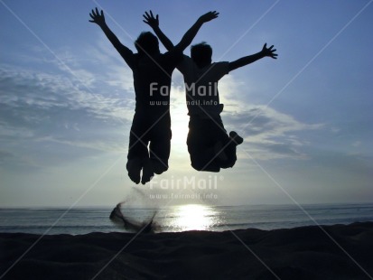 Fair Trade Photo 15-20 years, Activity, Backlit, Beach, Clouds, Colour image, Cooperation, Emotions, Evening, Friendship, Happiness, Horizontal, Jumping, Nature, Outdoor, People, Peru, Sand, Scenic, Sea, Silhouette, Sky, South America, Sun, Sunset, Two boys, Two children, Water