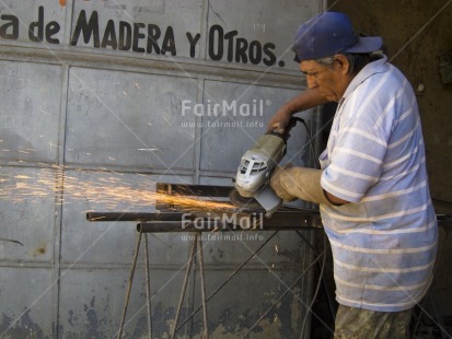 Fair Trade Photo 40-45 years, Activity, Casual clothing, Clothing, Colour image, Construction, Day, Fire, Horizontal, Latin, Looking away, Mechanic, One man, Outdoor, People, Peru, Portrait halfbody, South America, Working