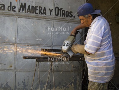 Fair Trade Photo 40-45 years, Activity, Casual clothing, Clothing, Colour image, Construction, Day, Fire, Horizontal, Latin, Looking away, Mechanic, One man, Outdoor, People, Peru, Portrait halfbody, South America, Working