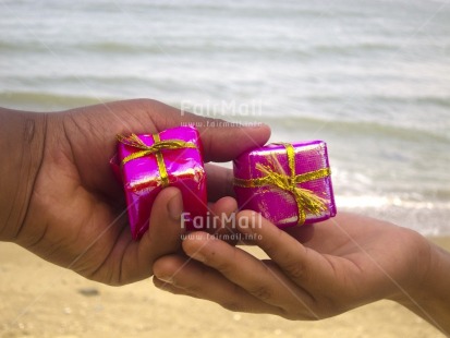 Fair Trade Photo Activity, Beach, Birthday, Closeup, Colour image, Gift, Giving, Hand, Horizontal, People, Peru, Pink, Sand, Seasons, South America, Summer, Water