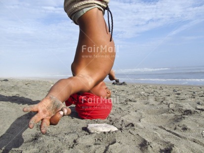 Fair Trade Photo 10-15 years, Activity, Balance, Beach, Colour image, Day, Horizontal, Multi-coloured, One boy, Outdoor, People, Peru, Portrait halfbody, Relaxing, Sand, Sea, South America, Spirituality, Wellness, Yoga