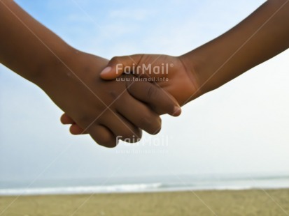 Fair Trade Photo 5-10 years, 5 -10 years, Beach, Care, Closeup, Colour image, Day, Friendship, Hand, Horizontal, Love, Outdoor, People, Peru, Sand, Seasons, South America, Summer, Together, Two children