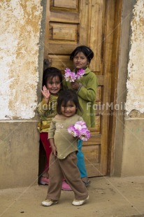 Fair Trade Photo Colour image, Door, Flower, Group of girls, House, People, Peru, Smiling, South America, Street, Streetlife, Vertical