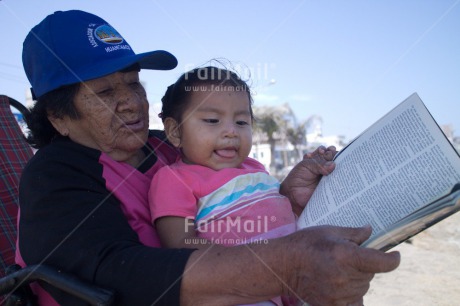 Fair Trade Photo Activity, Book, Care, Casual clothing, Clothing, Colour image, Day, Education, Family, Grandmother, Horizontal, Latin, One girl, One woman, Outdoor, People, Peru, Reading, South America, Teaching