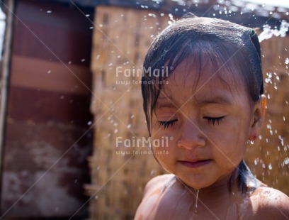 Fair Trade Photo 5 -10 years, Activity, Colour image, Dailylife, Day, Health, Horizontal, Latin, Looking away, One girl, Outdoor, People, Peru, Portrait headshot, Sanitation, Showering, South America, Washing, Water