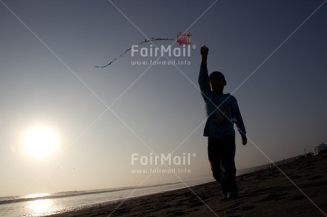 Fair Trade Photo Activity, Backlit, Beach, Colour image, Emotions, Evening, Freedom, Happiness, Kite, One boy, Outdoor, People, Peru, Playing, Sea, Silhouette, Sky, South America