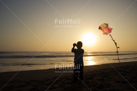 Fair Trade Photo 5 -10 years, Activity, Backlit, Beach, Colour image, Emotions, Evening, Freedom, Happiness, Kite, One boy, Outdoor, People, Peru, Playing, Sea, Silhouette, Sky, South America