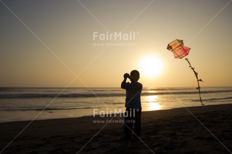 Fair Trade Photo 5 -10 years, Activity, Backlit, Beach, Colour image, Emotions, Evening, Freedom, Happiness, Kite, One boy, Outdoor, People, Peru, Playing, Sea, Silhouette, Sky, South America