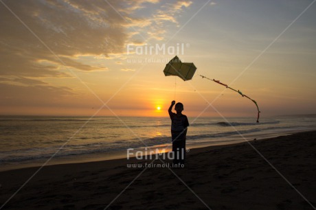 Fair Trade Photo 5 -10 years, Activity, Backlit, Beach, Colour image, Emotions, Evening, Freedom, Happiness, Kite, One boy, Outdoor, People, Peru, Playing, Sea, Silhouette, Sky, South America