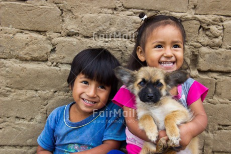 Fair Trade Photo 5 -10 years, Activity, Animals, Casual clothing, Clothing, Colour image, Cute, Dog, Emotions, Happiness, Latin, One boy, One girl, Outdoor, People, Peru, Playing, Portrait halfbody, Puppy, Smiling, South America, Streetlife, Two children