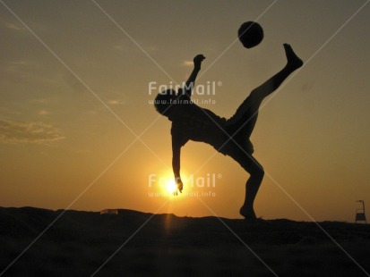 Fair Trade Photo 10-15 years, Activity, Backlit, Ball, Beach, Colour image, Evening, Horizontal, Jumping, Latin, Moving, One boy, Outdoor, People, Peru, Playing, Sand, Seasons, Silhouette, Sky, Soccer, South America, Sport, Summer, Sunset