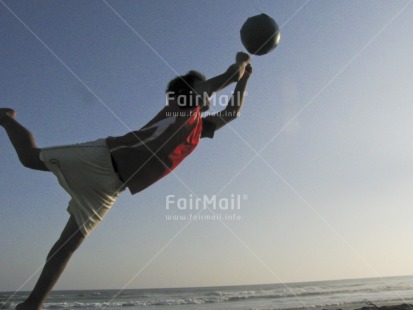 Fair Trade Photo 10-15 years, Activity, Ball, Beach, Colour image, Day, Horizontal, Jumping, Latin, Moving, One boy, Outdoor, People, Peru, Playing, Sand, Seasons, Sky, Soccer, South America, Sport, Summer