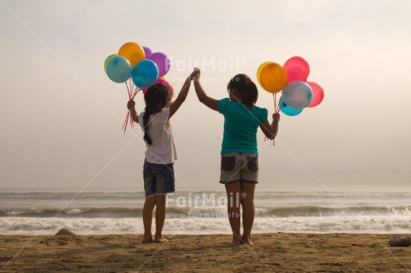 Fair Trade Photo Activity, Balloon, Beach, Birthday, Celebrating, Child, Colour image, Day, Emotions, Friendship, Girl, Happiness, Holding, Holding hands, Holiday, Horizontal, Multi-coloured, Ocean, Outdoor, People, Peru, Sand, Sea, Seasons, Sister, South America, Standing, Summer, Water