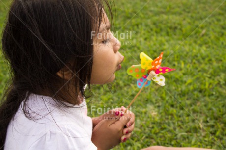 Fair Trade Photo Activity, Blowing, Child, Colour image, Day, Emotions, Friendship, Girl, Grass, Green, Happiness, Holding, Holiday, Horizontal, Multi-coloured, Nature, Outdoor, People, Peru, Playing, Seasons, Sister, South America, Summer, Windmill