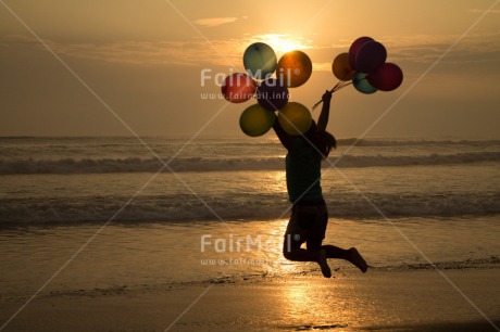 Fair Trade Photo Activity, Balloon, Beach, Birthday, Celebrating, Child, Colour image, Day, Emotions, Evening, Friendship, Girl, Happiness, Holding, Holiday, Horizontal, Jumping, Multi-coloured, Ocean, Outdoor, People, Peru, Sand, Sea, Seasons, Sister, South America, Summer, Sunset, Water