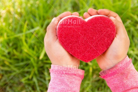 Fair Trade Photo Child, Colour image, Day, Fathers day, Girl, Grass, Green, Hands, Heart, Horizontal, Love, Mothers day, Nature, Outdoor, People, Peru, Red, South America, Valentines day