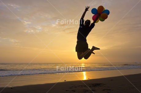 Fair Trade Photo Activity, Backlit, Balloon, Beach, Birthday, Colour image, Evening, Horizontal, Invitation, Jumping, One girl, Outdoor, Party, People, Peru, Sand, Silhouette, South America, Water