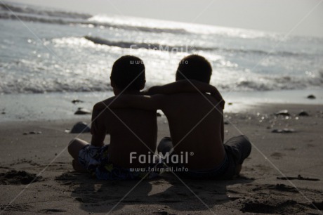 Fair Trade Photo Activity, Backlit, Beach, Colour image, Cooperation, Evening, Friendship, Hugging, Outdoor, People, Peru, Sand, Silhouette, Sitting, South America, Summer, Together, Two boys
