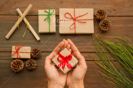 Fair Trade Photo Branch, Brown, Christmas, Colour image, Crafts, Gift, Green, Hands, Holding, Horizontal, Peru, Pine, Red, Ribbon, Seasons, South America, Table, Winter, Wood