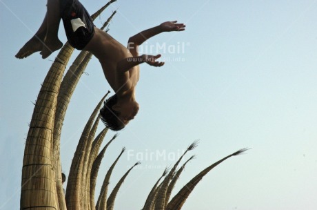 Fair Trade Photo Activity, Beach, Boat, Colour image, Day, Fishing boat, Freedom, Horizontal, Jumping, One boy, Outdoor, People, Peru, Playing, Seasons, Sky, South America, Strength, Summer
