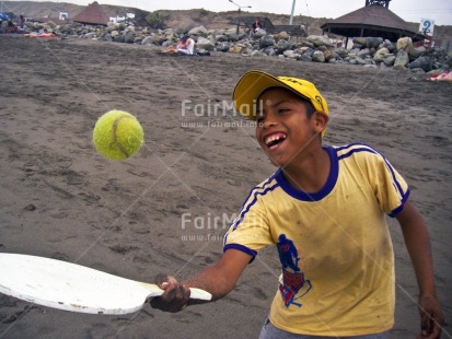 Fair Trade Photo 5-10 years, Activity, Ball, Beach, Cap, Colour image, Day, Emotions, Fun, Happiness, Horizontal, One boy, Outdoor, People, Peru, Playing, Portrait halfbody, Smile, Smiling, South America, Sport, Tennis, Yellow