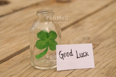 Fair Trade Photo Bottle, Clover, Colour image, Desk, Exams, Glass, Good luck, Green, Horizontal, Peru, School, South America, Success, Table, Text, White, Wood