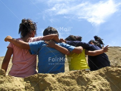 Fair Trade Photo Activity, Casual clothing, Clothing, Colour image, Cooperation, Day, Friendship, Group of children, Horizontal, Hugging, Outdoor, People, Peru, Playing, Rural, Seasons, Sitting, Sky, South America, Summer, Together